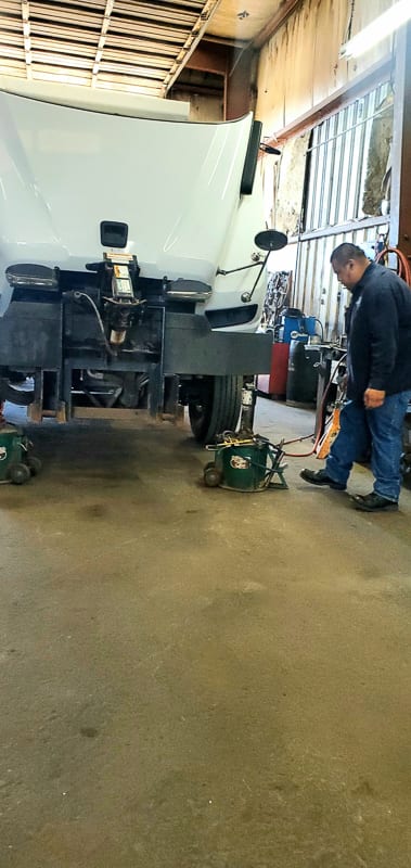 Heavy vehicle up on the alignment rack at Largo Frame & Alignment