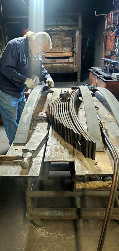 Leaf springs staged on the rack in the Largo spring shop